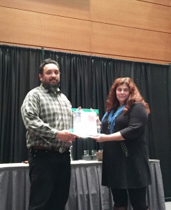 Ron Napoles receives the award from Brianna Candelaria BLM National Lead for Interpretation