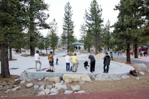 Skateboarders riding Little Brothers Skate Park with Pavilion small