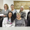 Tracy Aspel, NIHD’s Chief Nursing Officer, back row, far left, presents a $1,132 donation from the employees of NIHD to the Eastern Sierra Cancer Alliance Board of Director. The funds were raised through the sale of pink t-shirts during Breast Cancer Awareness Month. Shown accepting the donation from Aspel are ESCA Board members, left to right, back row: Andrea Shallcross, Norma Crider, Sherry Nostrant, and ESCA founder Pat Ramirez. Front row: Rose Graves, Cheryl Underhill and Debbie Christensen.  Photo by Barbara Laughon/Northern Inyo Healthcare District