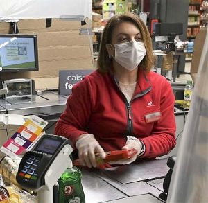 Grocery clerk wearing mask