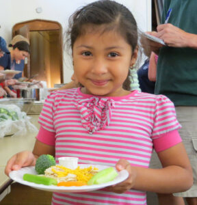 Little girl in soup kitchen